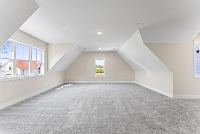 bonus room with carpet flooring and lofted ceiling