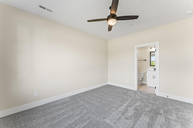 unfurnished bedroom featuring carpet, ceiling fan, and connected bathroom