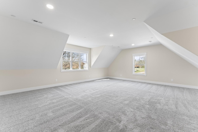 additional living space with carpet floors and lofted ceiling