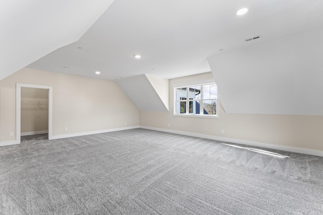 bonus room featuring carpet and vaulted ceiling