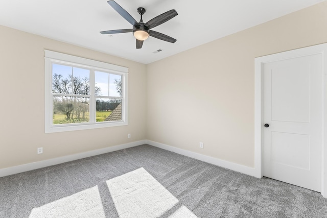 spare room featuring carpet flooring and ceiling fan