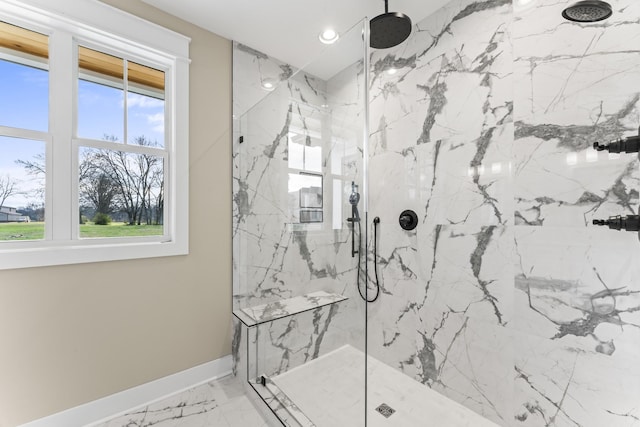 bathroom featuring a tile shower and a wealth of natural light