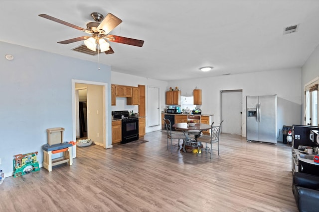 dining room featuring ceiling fan and light hardwood / wood-style floors