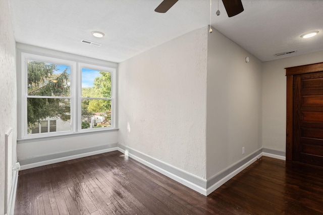 unfurnished room with dark hardwood / wood-style floors and ceiling fan