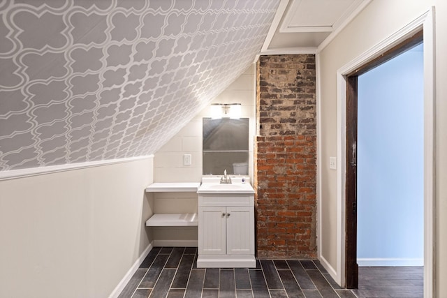 bathroom with vanity and lofted ceiling