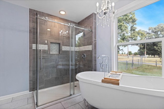 bathroom featuring tile patterned floors, separate shower and tub, and a notable chandelier