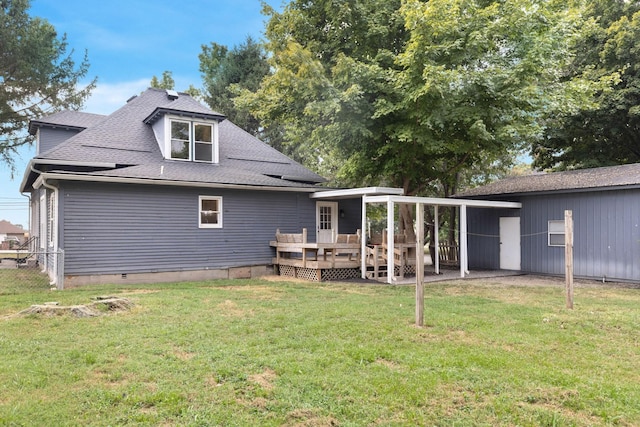 back of house featuring a yard and a deck