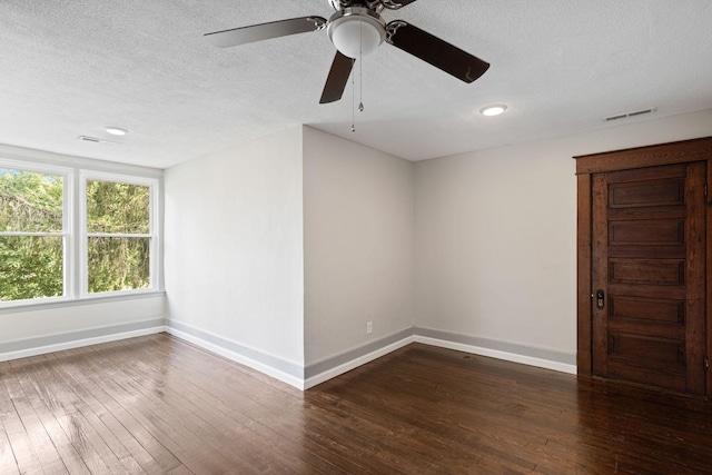 unfurnished room featuring dark hardwood / wood-style floors, ceiling fan, and a textured ceiling