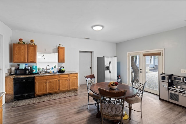 dining space featuring dark hardwood / wood-style flooring, sink, and french doors