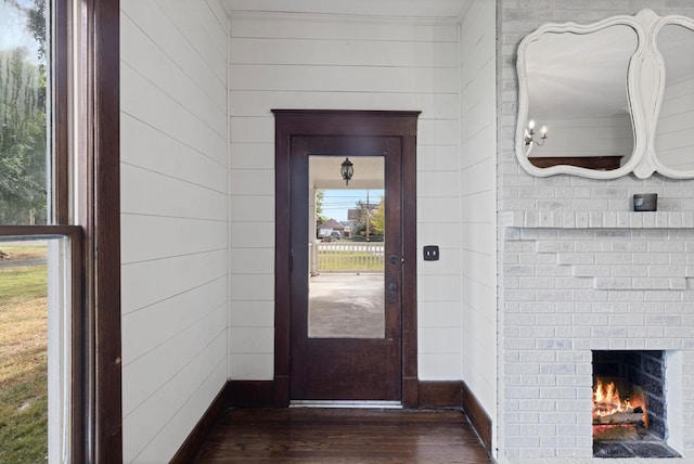 foyer with dark hardwood / wood-style flooring and a fireplace