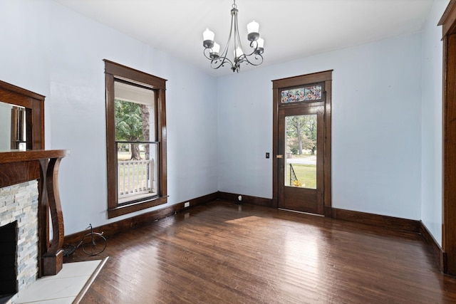 interior space with dark hardwood / wood-style flooring and an inviting chandelier