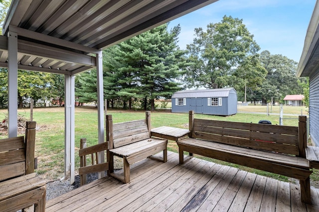 wooden terrace with a lawn and an outdoor structure