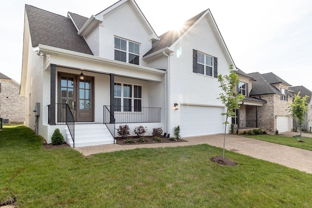 view of front of property with french doors, a front lawn, a porch, and a garage