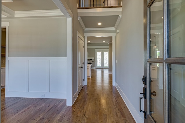 hallway featuring wood-type flooring, french doors, and crown molding