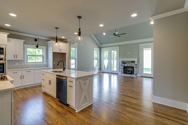 kitchen with a center island with sink, sink, white cabinets, and stainless steel appliances