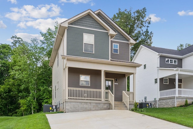 view of front of property with covered porch, a front lawn, and central air condition unit