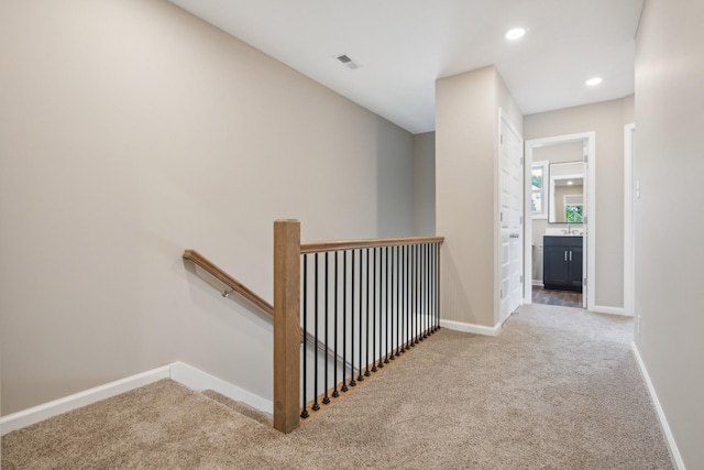 corridor featuring carpet and sink