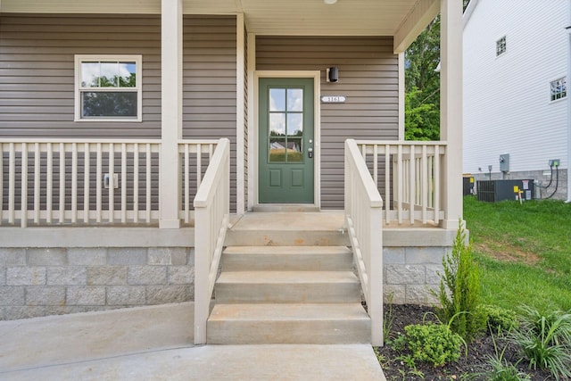 property entrance featuring covered porch and central AC