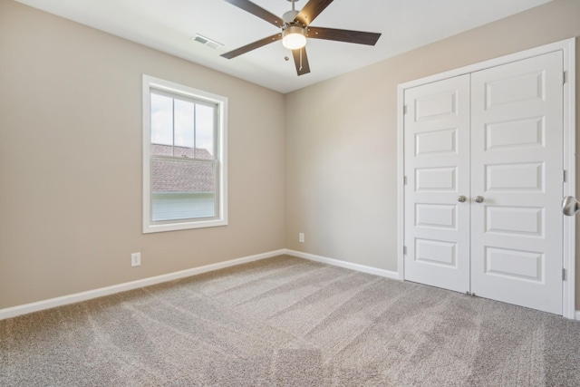 empty room featuring carpet and ceiling fan