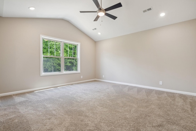 unfurnished room with carpet flooring, ceiling fan, and vaulted ceiling