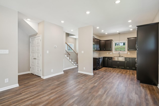 kitchen with dishwasher, sink, pendant lighting, and dark hardwood / wood-style floors