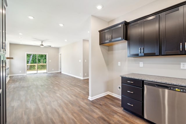 kitchen featuring dark brown cabinetry, ceiling fan, dishwasher, light stone counters, and hardwood / wood-style flooring