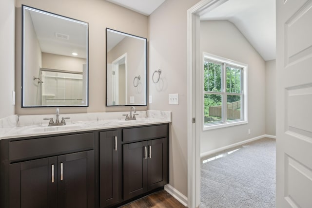 bathroom with vanity and vaulted ceiling