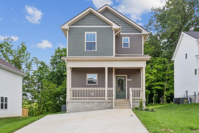 craftsman house with a porch, central AC, and a front lawn