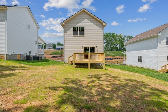 rear view of property with central air condition unit, a yard, and a deck