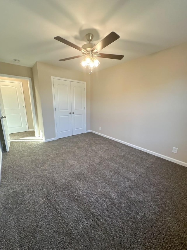 unfurnished bedroom featuring a closet, dark carpet, and ceiling fan