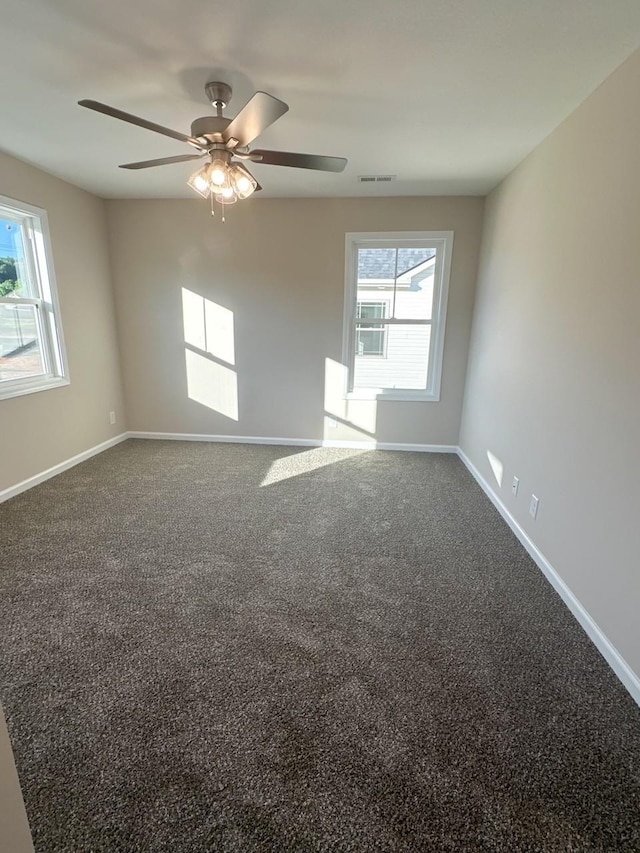 carpeted spare room featuring ceiling fan