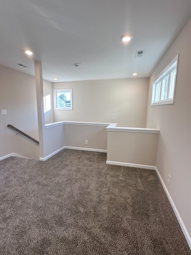 empty room featuring dark colored carpet