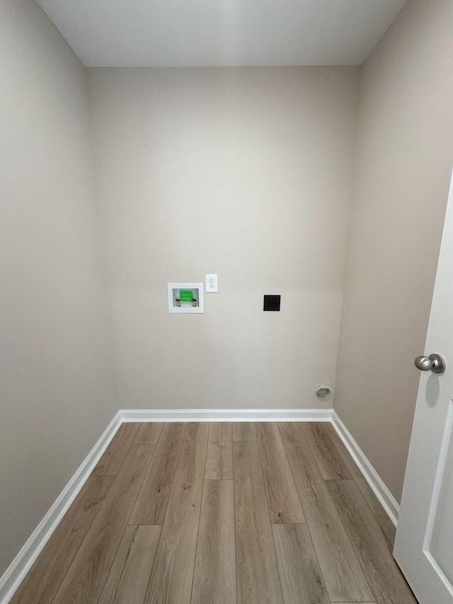 laundry area with washer hookup and light hardwood / wood-style floors