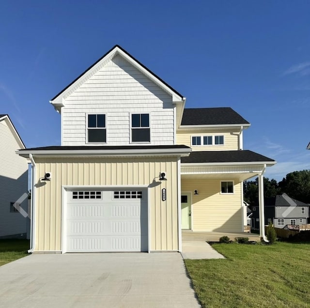 view of front of house with a front lawn and a garage