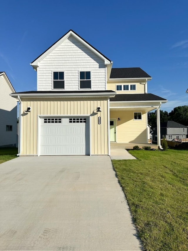 view of front of house featuring a porch, a garage, and a front lawn