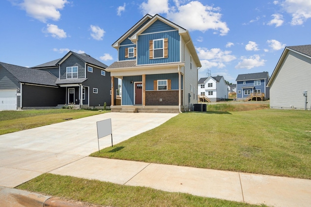 view of front of home with central AC unit, a porch, and a front yard