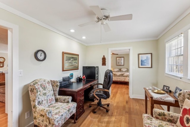 office space featuring light wood-type flooring, ceiling fan, and ornamental molding