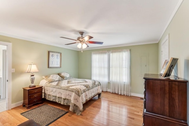 bedroom featuring ceiling fan, light hardwood / wood-style flooring, and ornamental molding