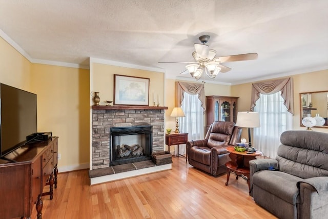 living room with hardwood / wood-style floors, ceiling fan, plenty of natural light, and ornamental molding