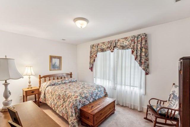 bedroom featuring light carpet