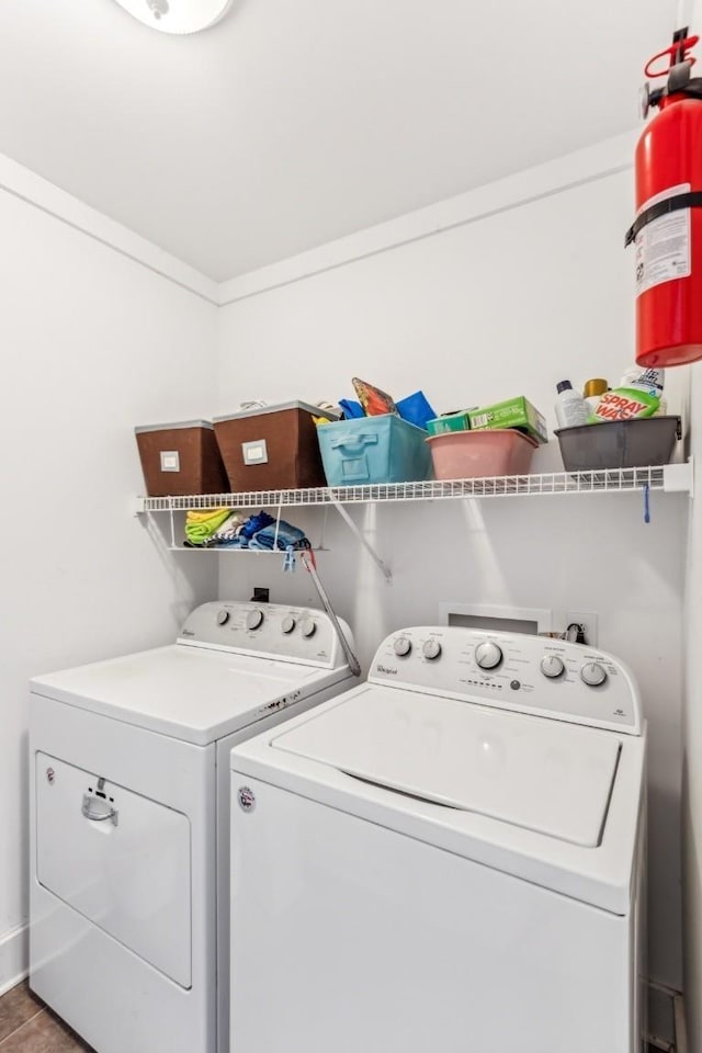 washroom featuring tile patterned flooring, ornamental molding, and independent washer and dryer