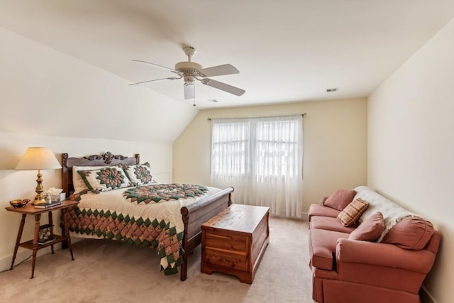 carpeted bedroom with vaulted ceiling and ceiling fan