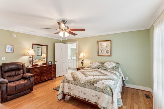 bedroom featuring ceiling fan, light hardwood / wood-style floors, and ensuite bathroom