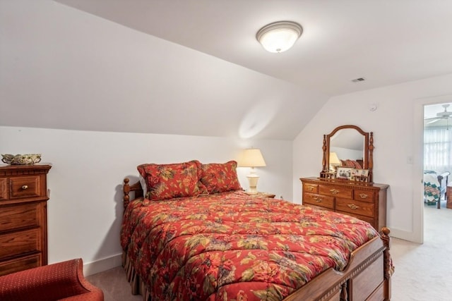 bedroom with light carpet and lofted ceiling