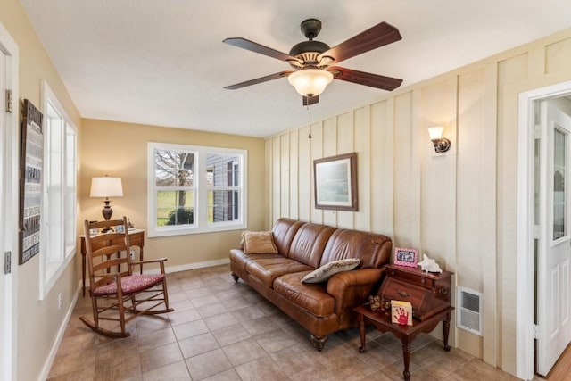 living room with light tile patterned floors and ceiling fan