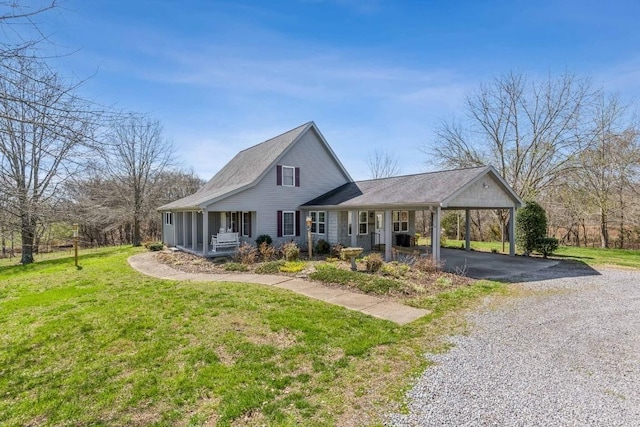 view of front of property featuring a front yard, a carport, and covered porch