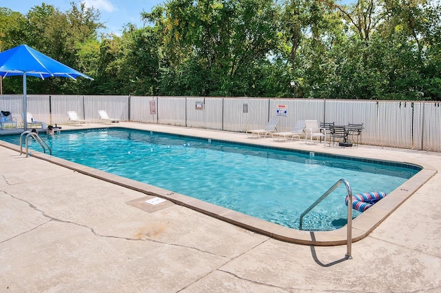 view of swimming pool featuring a patio area