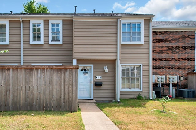 multi unit property featuring central AC and a front lawn