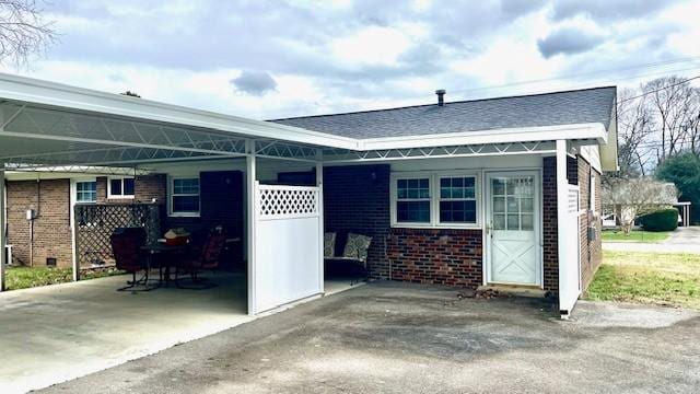 back of house featuring a carport