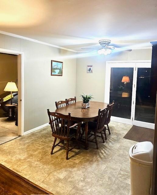 dining space with ceiling fan and ornamental molding